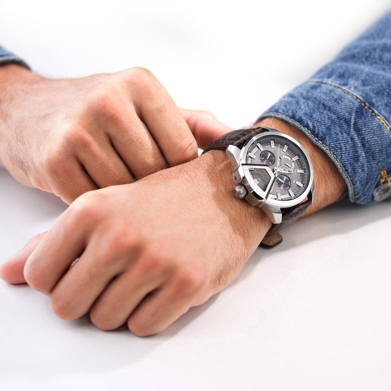 Stylish men’s wristwatch with a black leather strap and silver chronograph face.