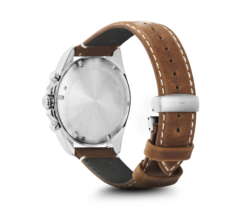 Wristwatch with a silver case and brown leather strap.