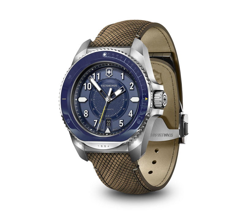 Wristwatch with a blue dial and brown fabric strap.