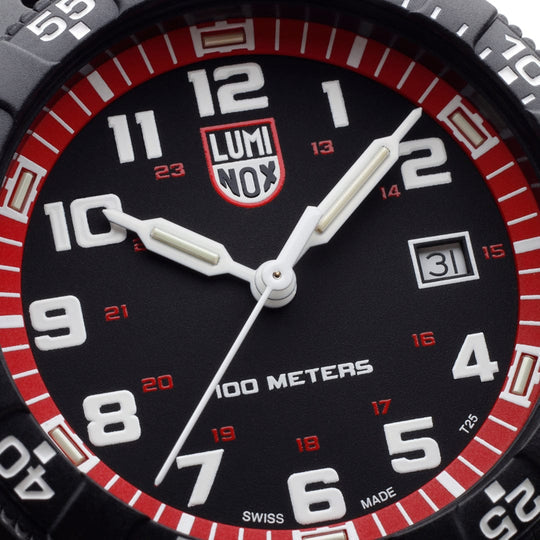 Luminox wristwatch face with a black dial, red bezel, and white numerals.