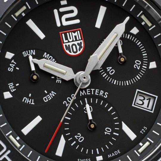 Close-up view of a Luminox watch face with chronograph subdials and date display.