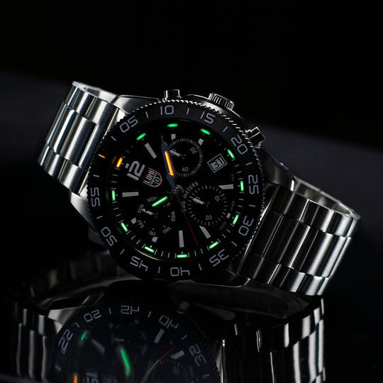 Sleek stainless steel wristwatch with a black face and luminous markings.