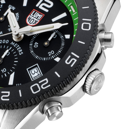 Luxury sports chronograph wristwatch with a black dial and green bezel accent.