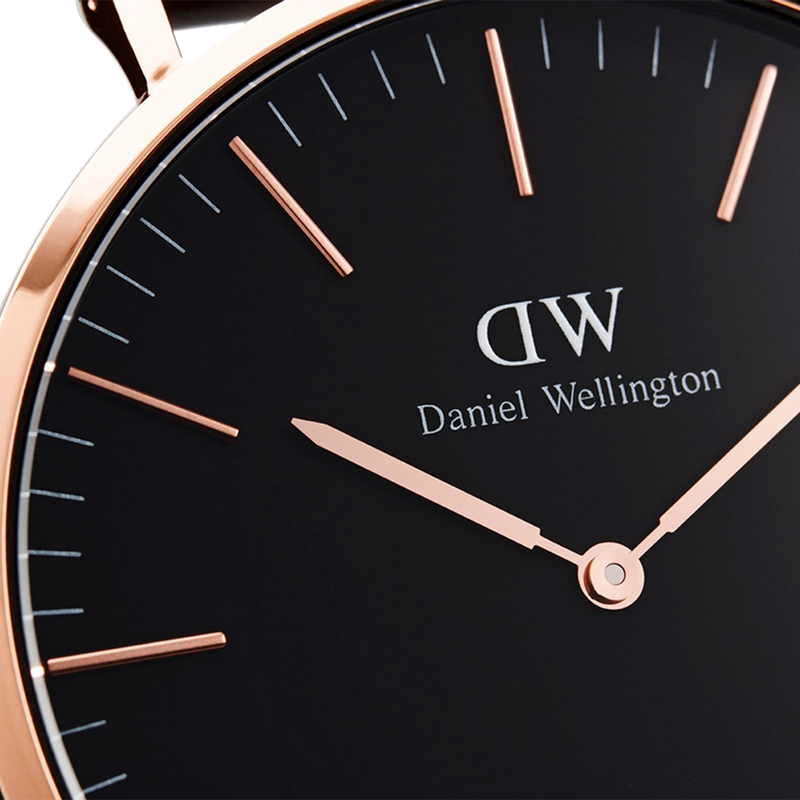 Elegant Daniel Wellington wristwatch with a black face and rose gold accents.