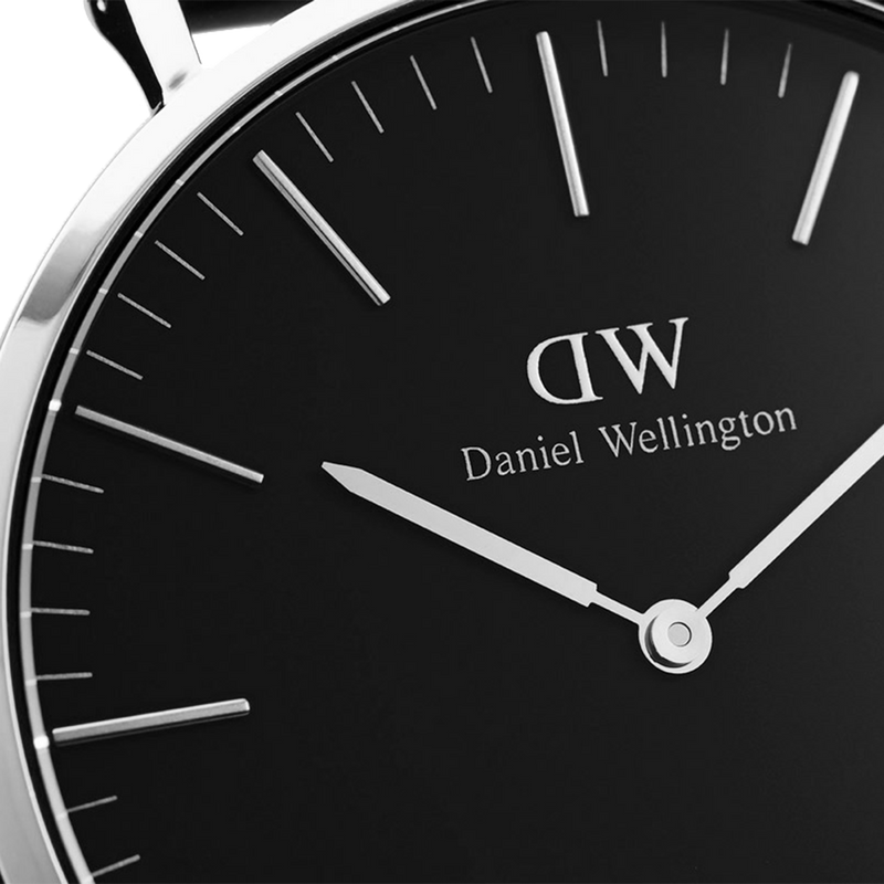 Sleek black-faced wristwatch with white hands and markings, displaying the Daniel Wellington brand.