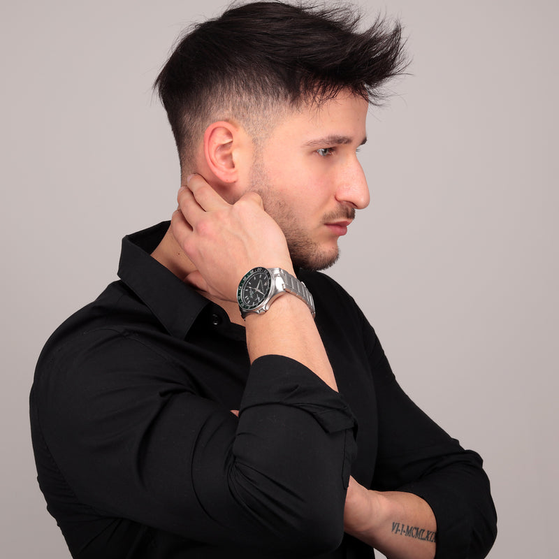 Man with short dark hair wearing a black shirt and silver watch.