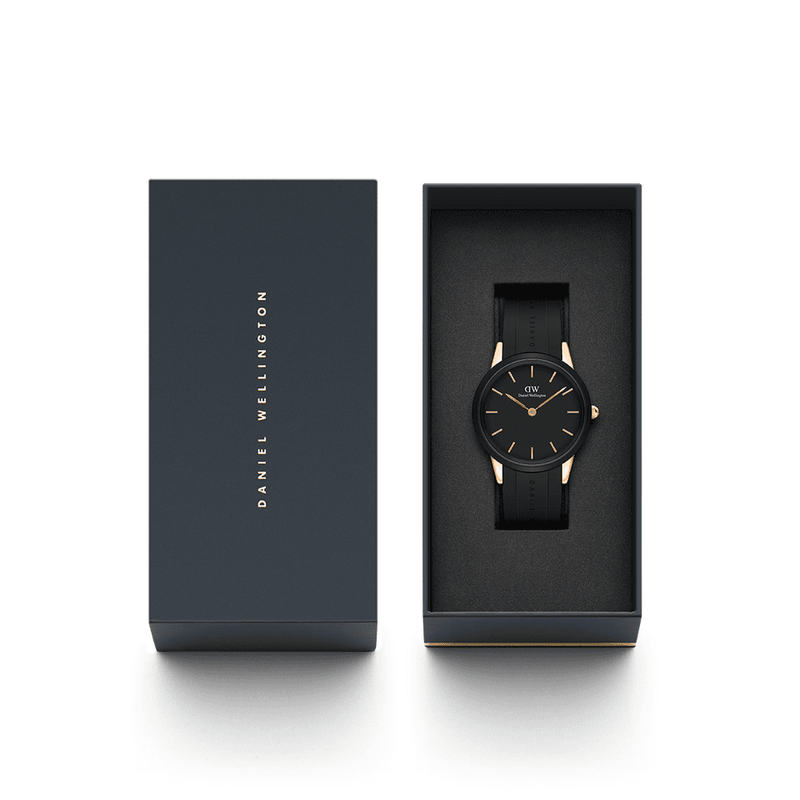 Sleek black wristwatch with gold accents in an elegant packaging box.