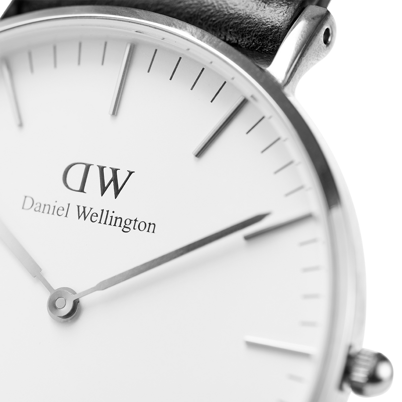 Daniel Wellington wristwatch with a minimalist white dial and black leather strap.