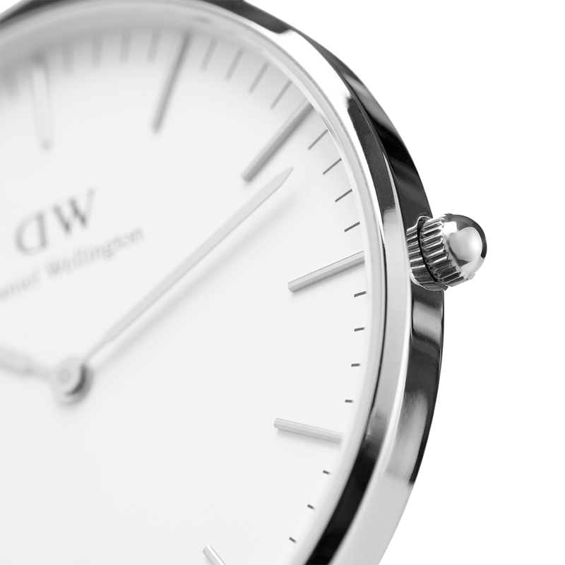 Sleek analog wristwatch with a minimalist white face and silver case.