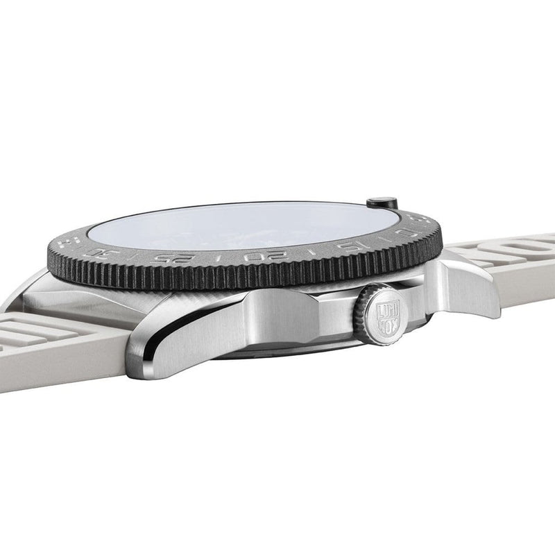 Side view of a wristwatch with a textured bezel and white strap.