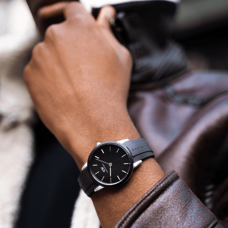 Sleek black wristwatch with a minimalist dial and leather strap.